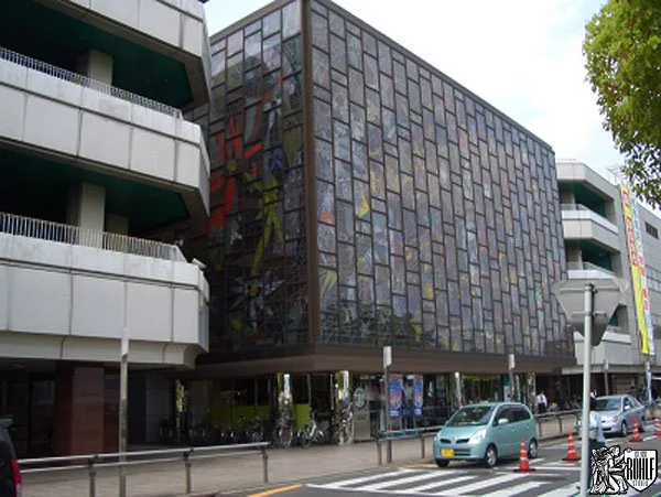 A large contemporary stained glass window installed in a shopping centre interior.