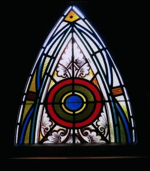 The same Yale Repertory Theatre window after restoration, colours clear and lead lines sound.